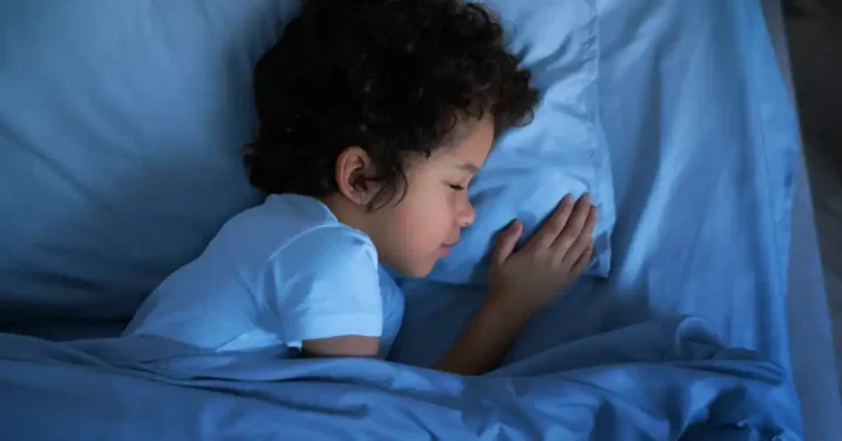 child sleeping in bed