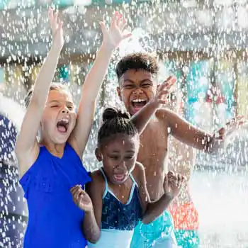 kid with ostomy playing in water